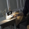3-in-1 bedside lamp with wireless charging pad, adjustable light settings, and built-in clock